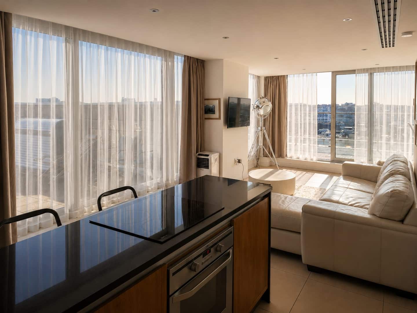Kitchen island and sofa in the open-plan penthouse living space